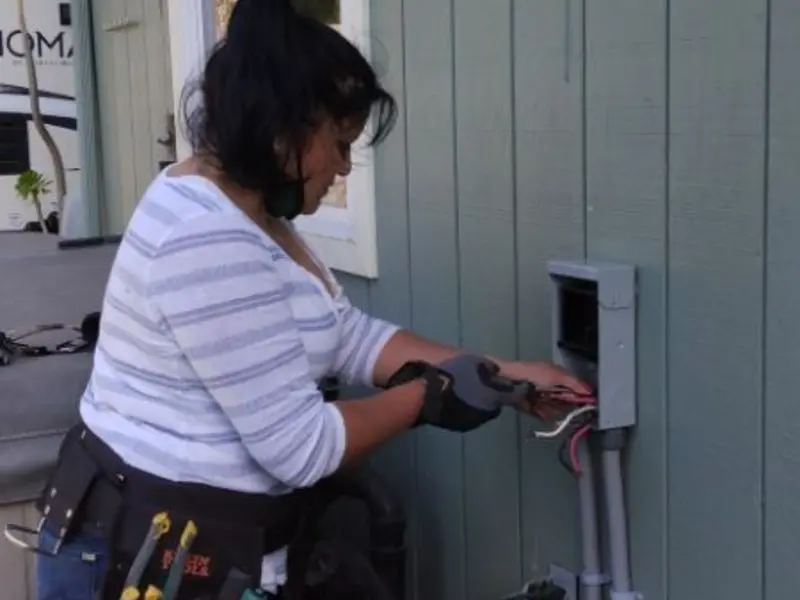Licensed electrician wiring an exterior subpanel in Fontana